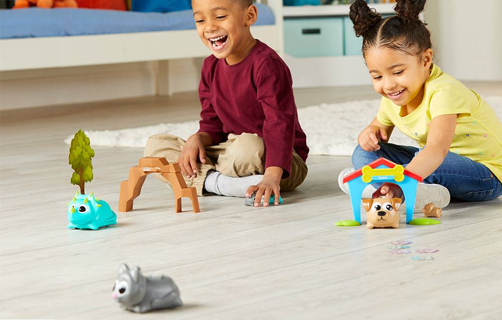 boy and girl playing with coding robot