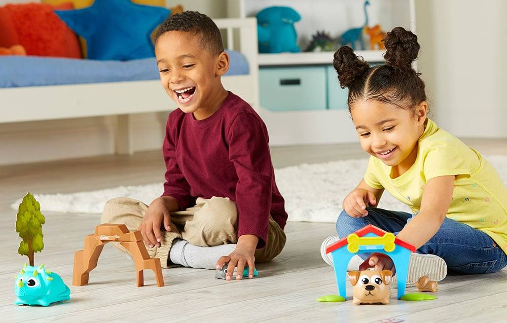 boy and girl playing with coding robot