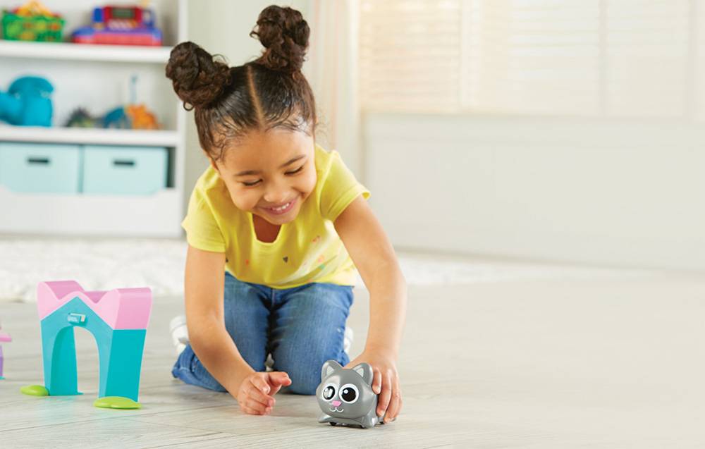 girl playing with coding robot